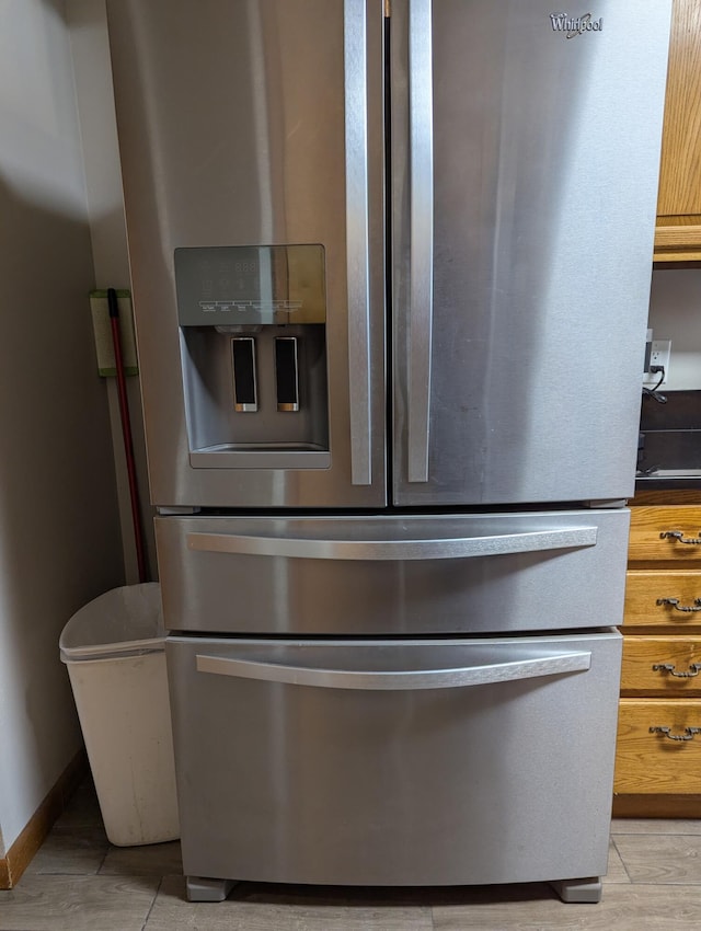 details featuring stainless steel refrigerator with ice dispenser