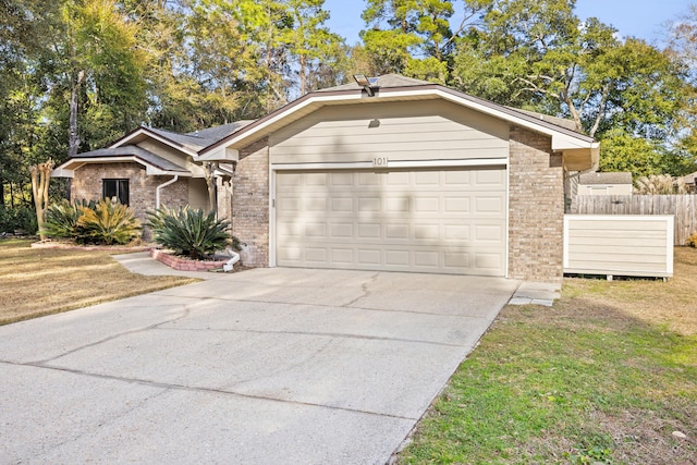 single story home featuring a garage and a front yard