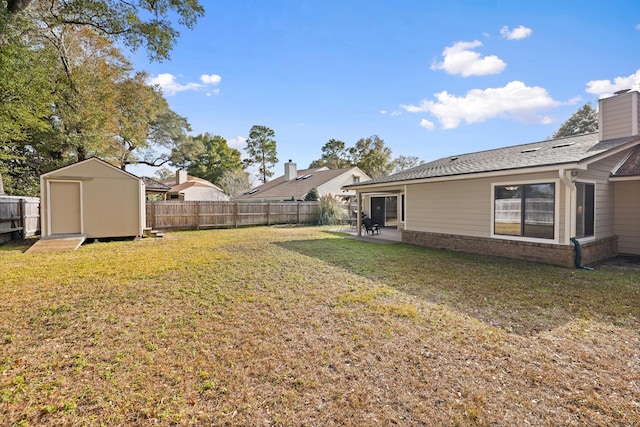 view of yard with a patio area and a storage shed