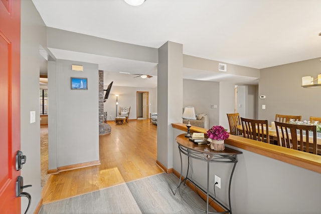 foyer entrance featuring ceiling fan and light wood-type flooring