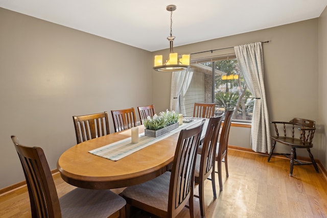 dining room featuring an inviting chandelier and light wood-type flooring