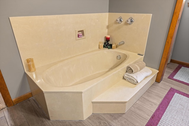 bathroom featuring hardwood / wood-style flooring and a bathtub