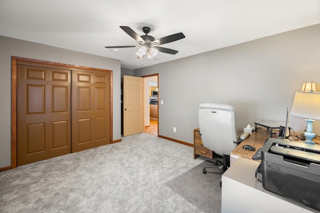 home office with ceiling fan and light carpet