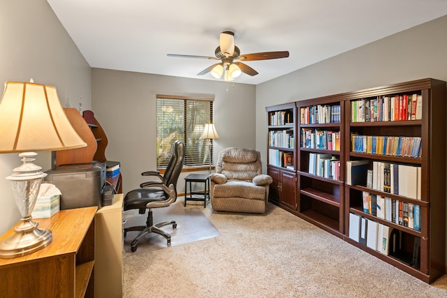 carpeted office space with ceiling fan