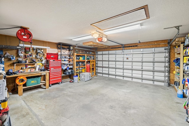 garage featuring a garage door opener and a workshop area