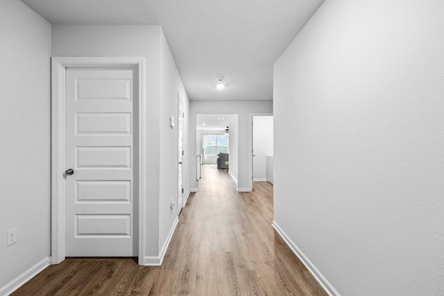 corridor with wood-type flooring