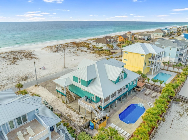 drone / aerial view featuring a water view and a view of the beach