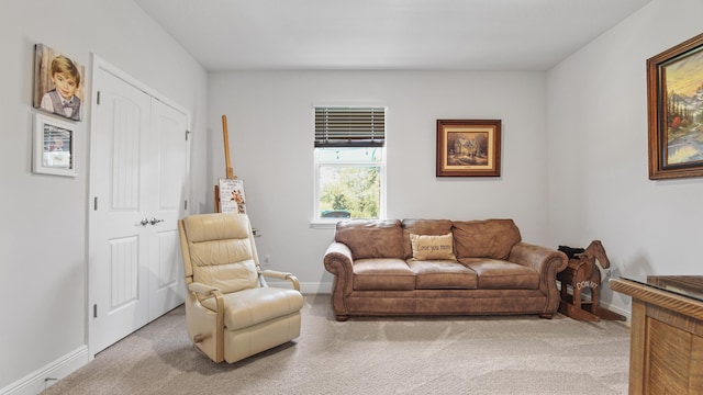 living room featuring carpet flooring and baseboards