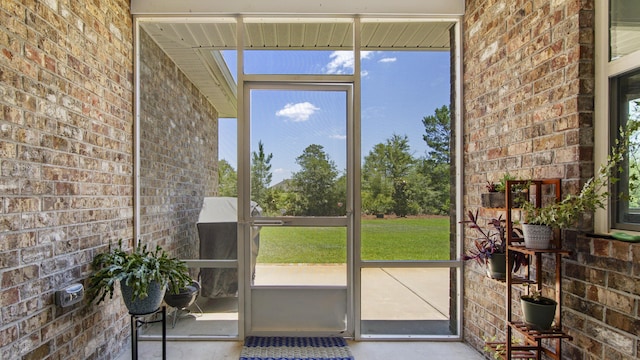 entryway featuring brick wall