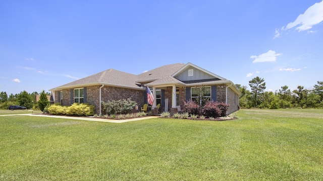 view of front of home with board and batten siding, a front yard, and brick siding