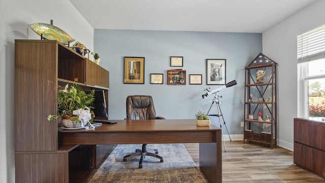 office space with light wood-style flooring and baseboards