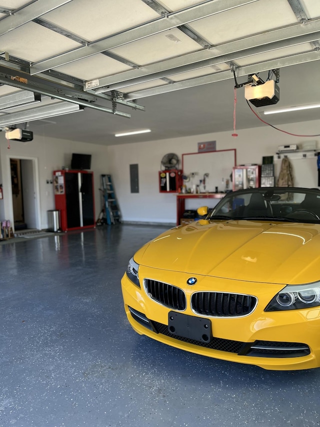 garage featuring electric panel and a garage door opener