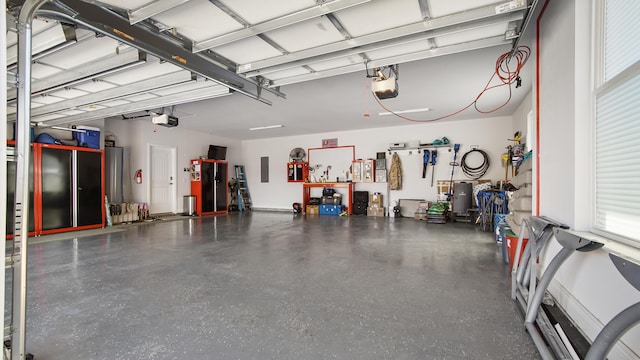 garage with electric panel and a garage door opener