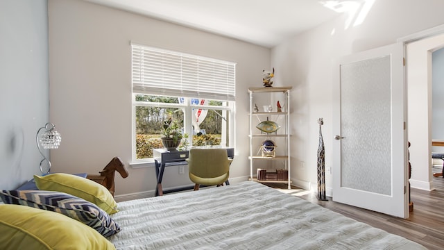 bedroom featuring baseboards and wood finished floors