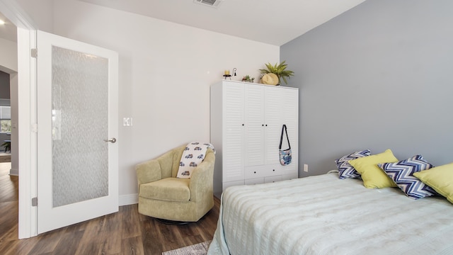 bedroom featuring a closet, visible vents, and wood finished floors