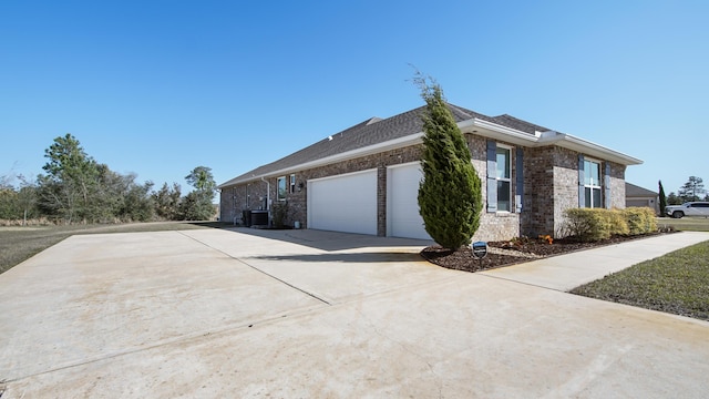 view of home's exterior featuring a garage, driveway, brick siding, and central AC unit