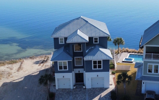 drone / aerial view with a water view and a beach view