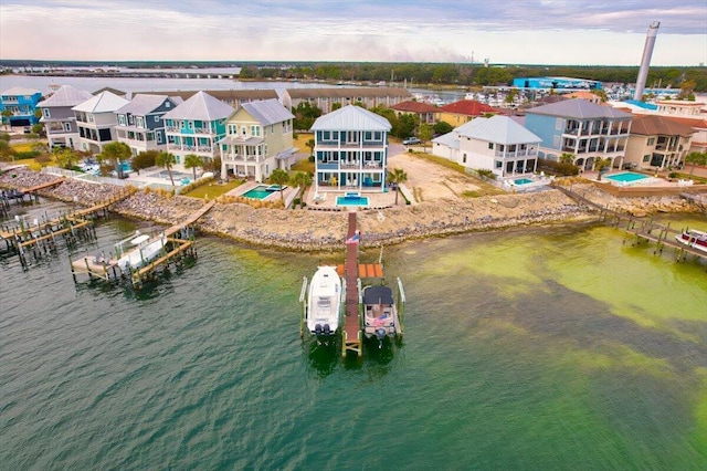 aerial view at dusk featuring a water view