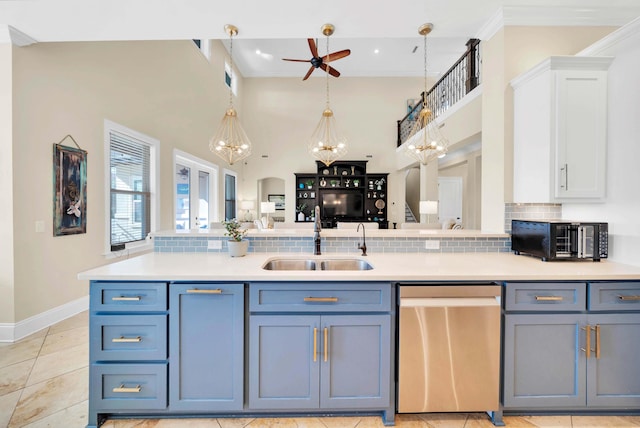 kitchen with light tile patterned floors, stainless steel dishwasher, backsplash, ceiling fan with notable chandelier, and sink