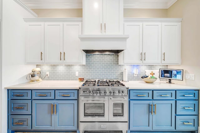 kitchen with blue cabinetry, backsplash, range with two ovens, and white cabinetry