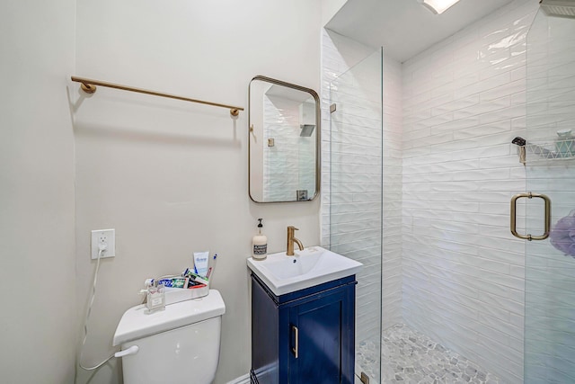 bathroom featuring an enclosed shower, vanity, and toilet