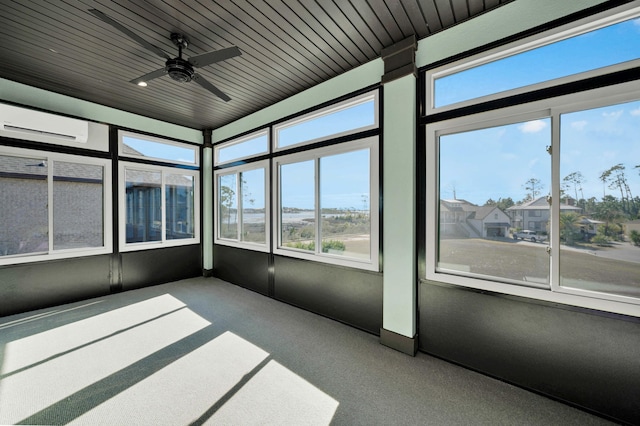 unfurnished sunroom featuring ceiling fan, an AC wall unit, and wooden ceiling