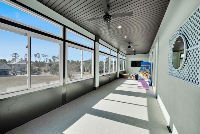 sunroom / solarium featuring ceiling fan and wood ceiling