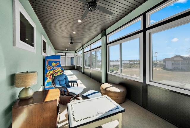 sunroom featuring ceiling fan and wood ceiling