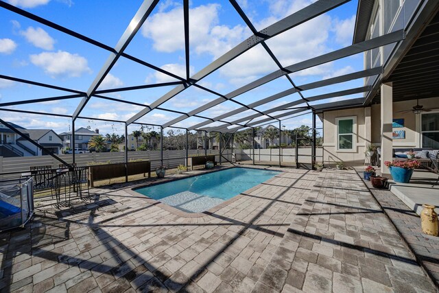 view of pool featuring a lanai, ceiling fan, and a patio