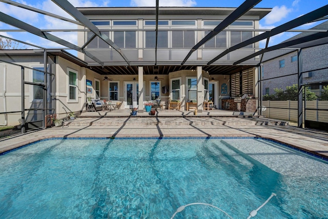 view of pool featuring ceiling fan, a patio area, and a lanai