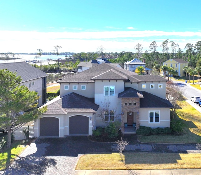 view of front of house featuring a garage and a water view