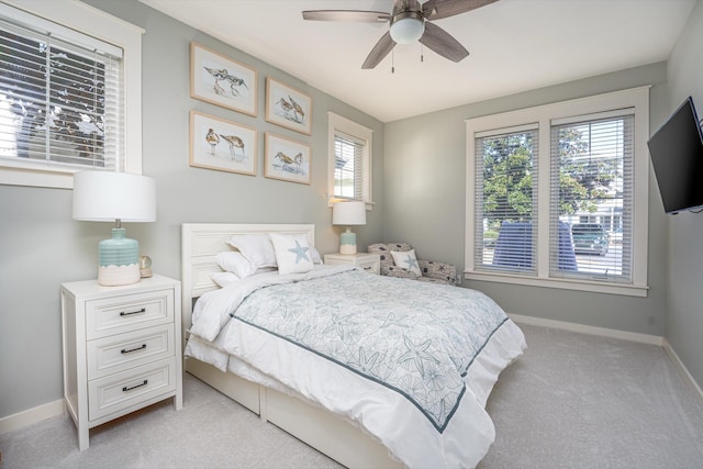 carpeted bedroom with multiple windows and ceiling fan