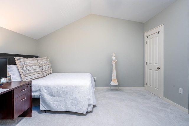 bedroom featuring vaulted ceiling and light carpet