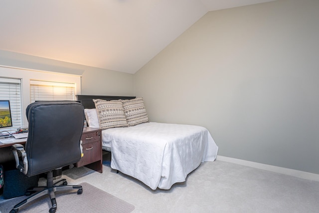 bedroom with light colored carpet and vaulted ceiling