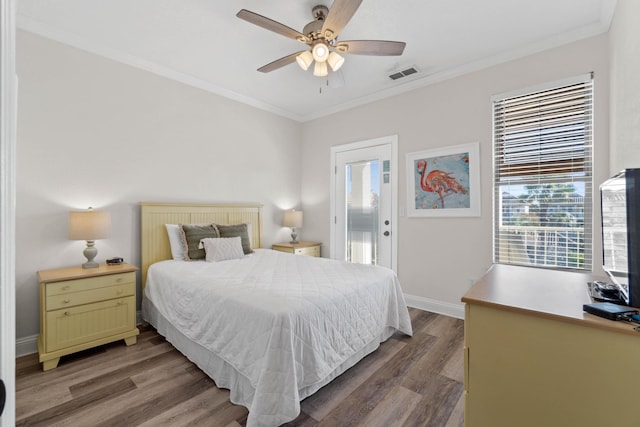 bedroom featuring ceiling fan, multiple windows, wood-type flooring, and crown molding