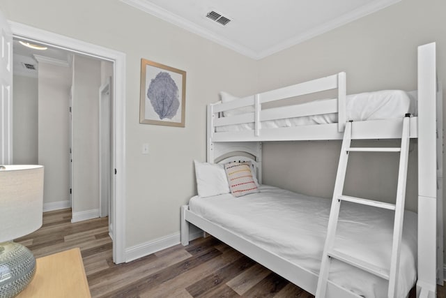 bedroom featuring dark hardwood / wood-style floors and crown molding