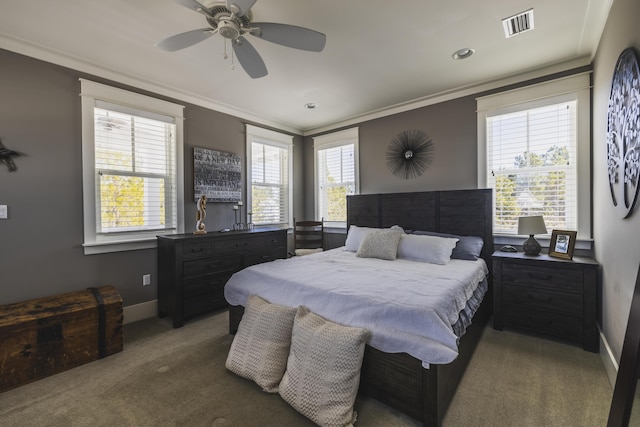 carpeted bedroom with crown molding, ceiling fan, and multiple windows