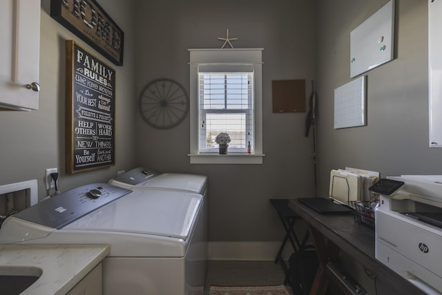 washroom with cabinets and washer and dryer