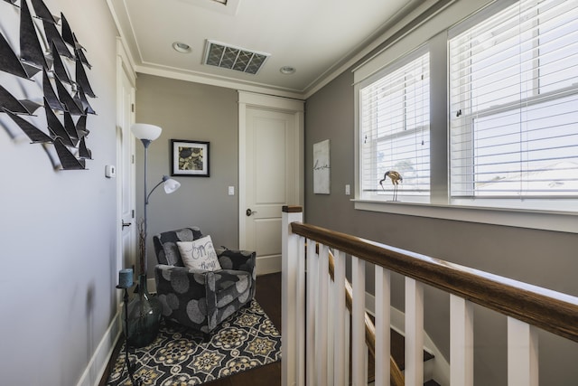 corridor with ornamental molding and hardwood / wood-style floors