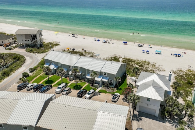 bird's eye view featuring a water view and a beach view