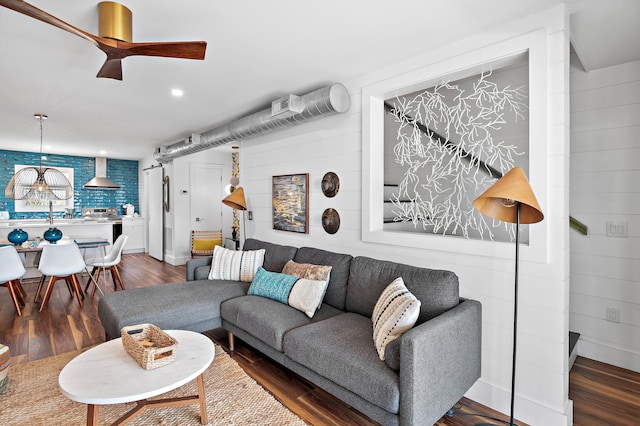 living room featuring dark hardwood / wood-style floors and ceiling fan