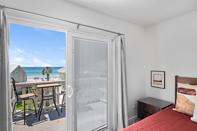 bedroom featuring a water view, a beach view, and hardwood / wood-style flooring