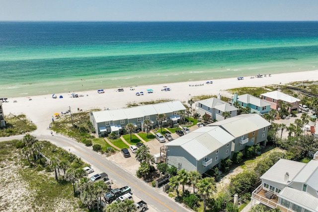 birds eye view of property featuring a water view and a beach view