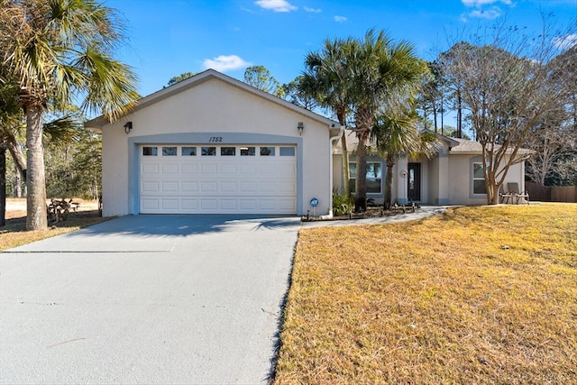 single story home featuring a garage and a front lawn