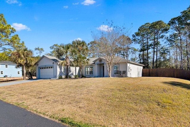 ranch-style home with a garage and a front lawn