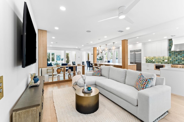 living room featuring light hardwood / wood-style floors and ceiling fan