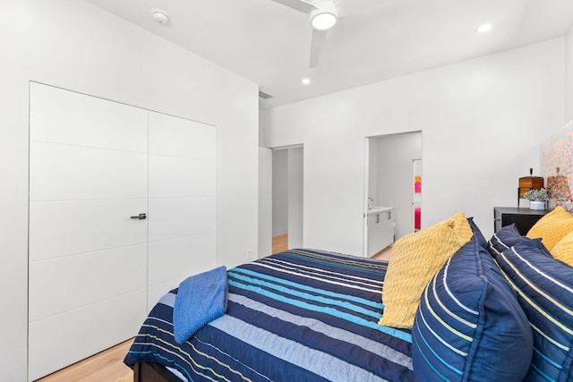 bedroom featuring ceiling fan, hardwood / wood-style flooring, and a closet