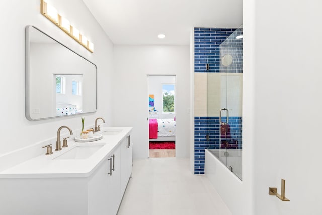 bathroom featuring walk in shower, vanity, and tile patterned flooring