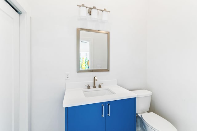 bathroom featuring toilet and vanity