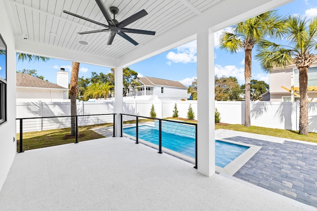 view of swimming pool featuring ceiling fan and a patio area